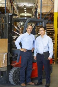 warehouse workers in front of forklift